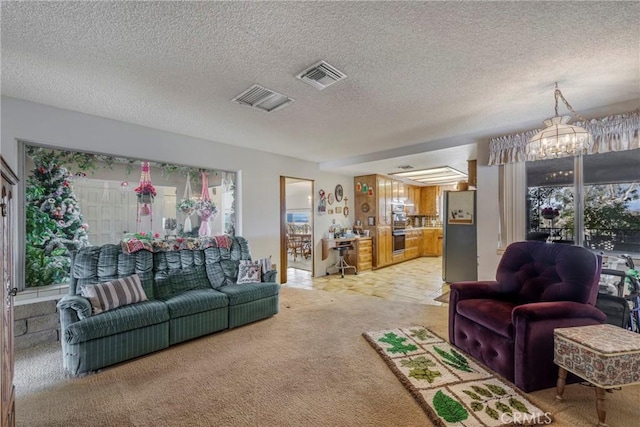 carpeted living area featuring an inviting chandelier, plenty of natural light, and visible vents