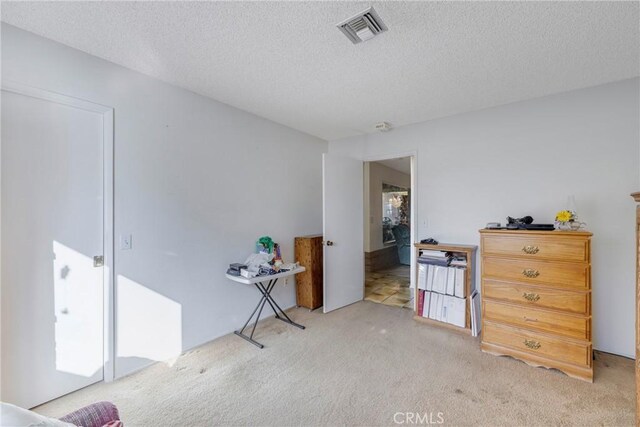 carpeted bedroom with a textured ceiling