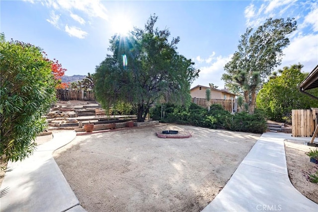 view of patio / terrace featuring fence and a fire pit