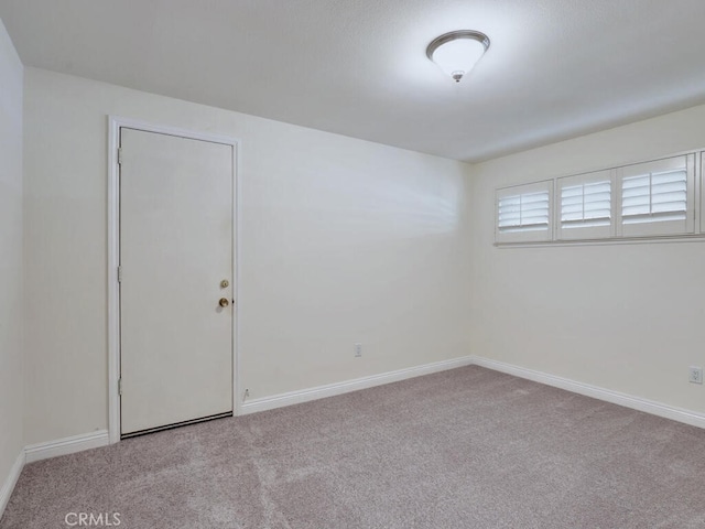 unfurnished room with light colored carpet