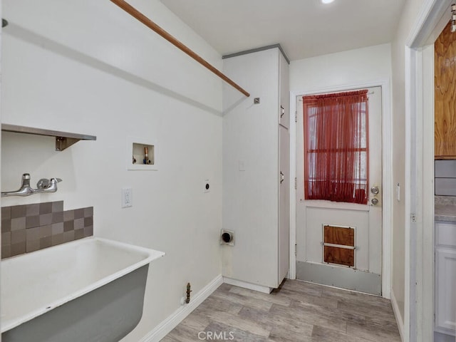 washroom featuring washer hookup, light hardwood / wood-style floors, sink, and hookup for an electric dryer