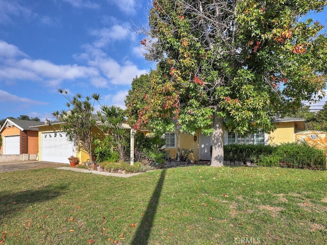 view of property hidden behind natural elements featuring a front yard and a garage