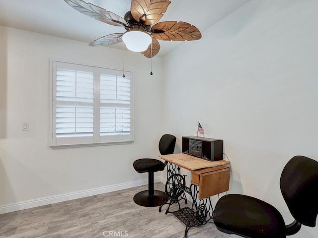 office area with light hardwood / wood-style flooring and ceiling fan