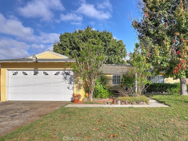 ranch-style home with a front yard and a garage