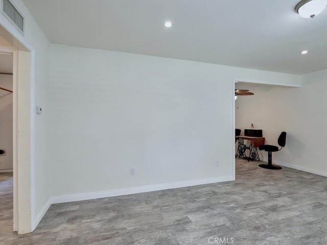 empty room with light hardwood / wood-style flooring