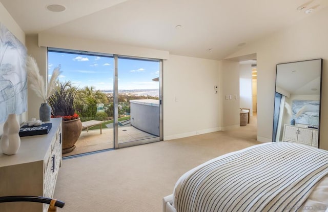 bedroom featuring lofted ceiling, access to exterior, and light carpet