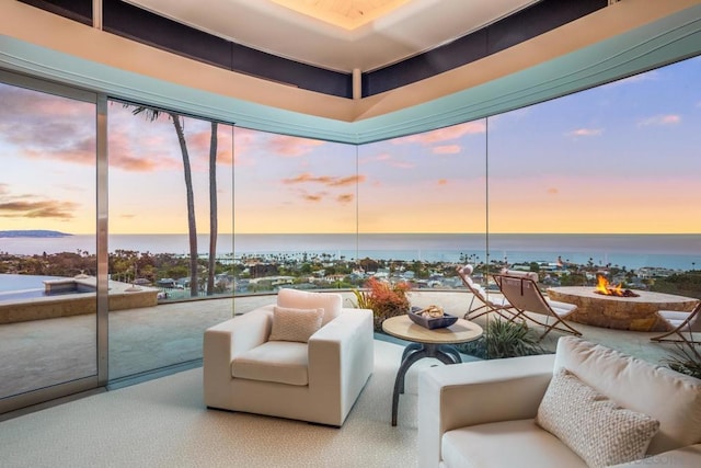 sunroom / solarium featuring a water view