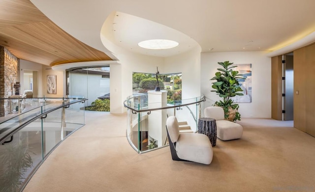 hallway featuring vaulted ceiling and light carpet