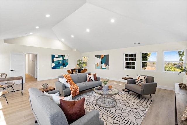 living room featuring light hardwood / wood-style floors and vaulted ceiling