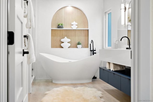 bathroom featuring vanity and a tub