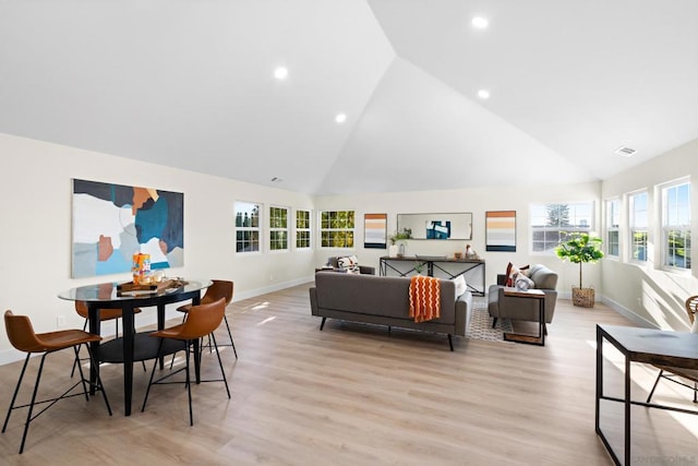 living room featuring light hardwood / wood-style flooring and vaulted ceiling