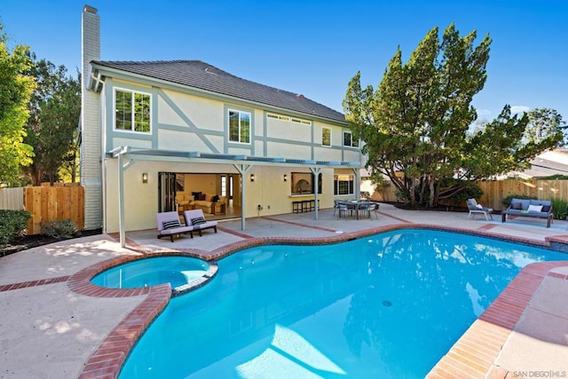 view of pool featuring an in ground hot tub and a patio