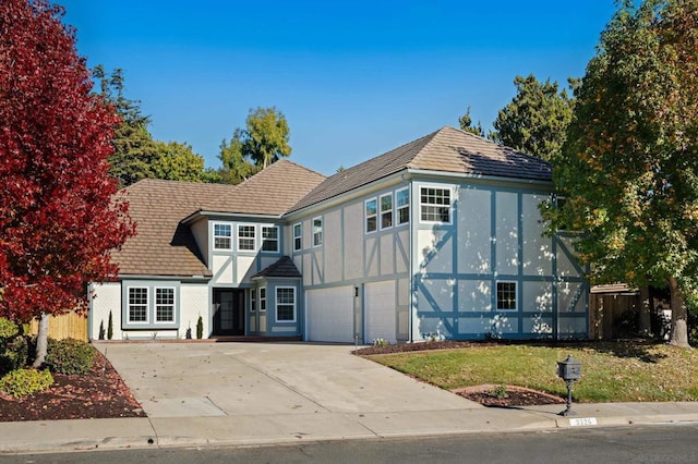 tudor home featuring a garage