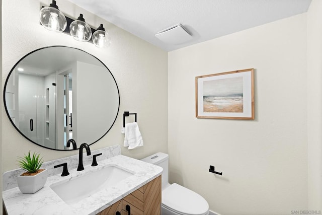 bathroom with toilet and vanity