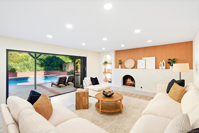 living room with light hardwood / wood-style floors and wooden walls