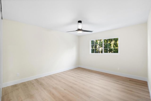 spare room with light wood-type flooring and ceiling fan