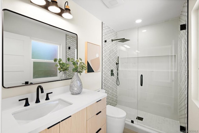 bathroom with vanity, walk in shower, and toilet