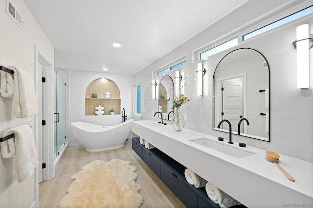 bathroom featuring wood-type flooring, vanity, and independent shower and bath