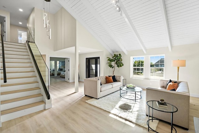 living room featuring wood ceiling, high vaulted ceiling, light hardwood / wood-style flooring, and beamed ceiling