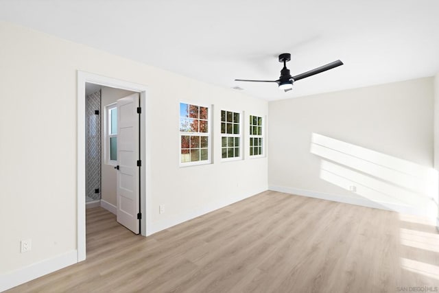 spare room featuring ceiling fan and light hardwood / wood-style flooring