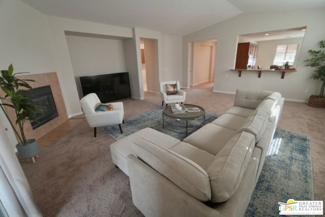 carpeted living room with vaulted ceiling