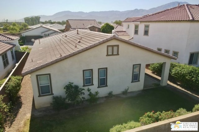 back of house featuring a mountain view