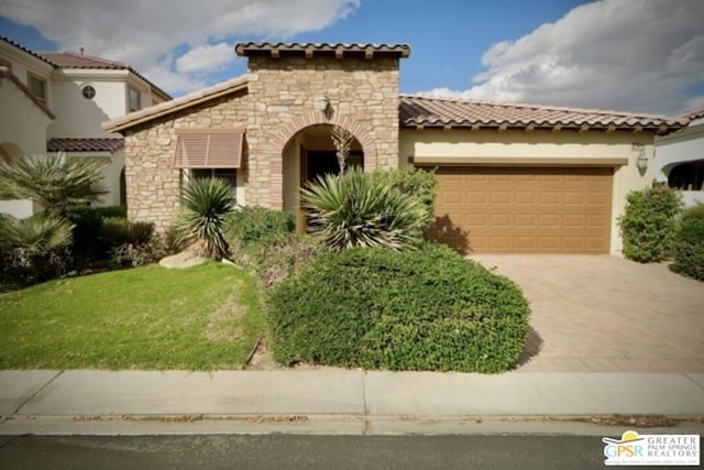 mediterranean / spanish home featuring a garage