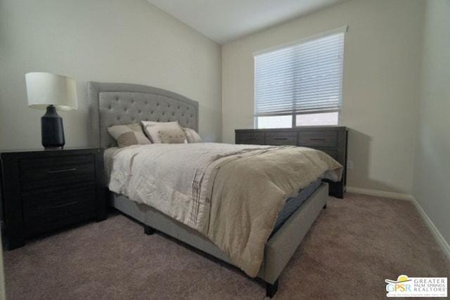 carpeted bedroom with lofted ceiling