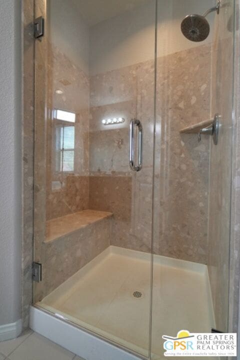 bathroom with tile patterned floors and an enclosed shower