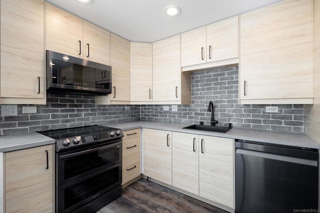 kitchen with double oven range, dark hardwood / wood-style floors, light brown cabinets, sink, and fridge