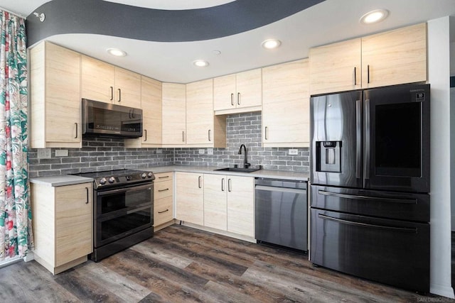 kitchen featuring appliances with stainless steel finishes, dark hardwood / wood-style flooring, light brown cabinets, sink, and backsplash