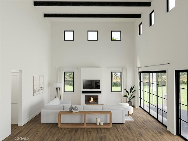 living room featuring hardwood / wood-style floors, beam ceiling, and a towering ceiling