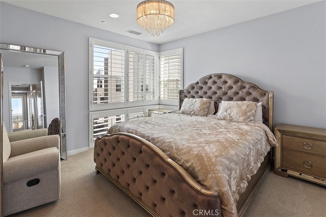 bedroom with an inviting chandelier and light colored carpet