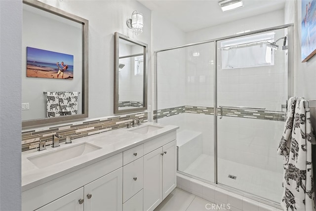 bathroom featuring vanity, tile patterned floors, an enclosed shower, and decorative backsplash