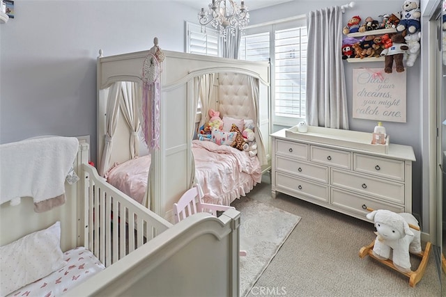 bedroom with a chandelier and light carpet