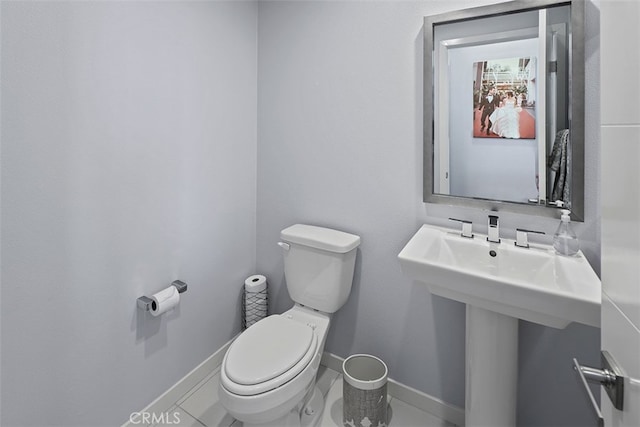 bathroom featuring tile patterned flooring and toilet