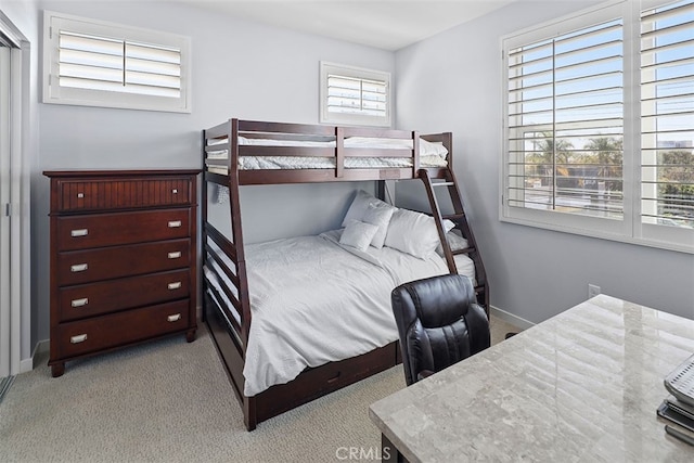 bedroom featuring light carpet