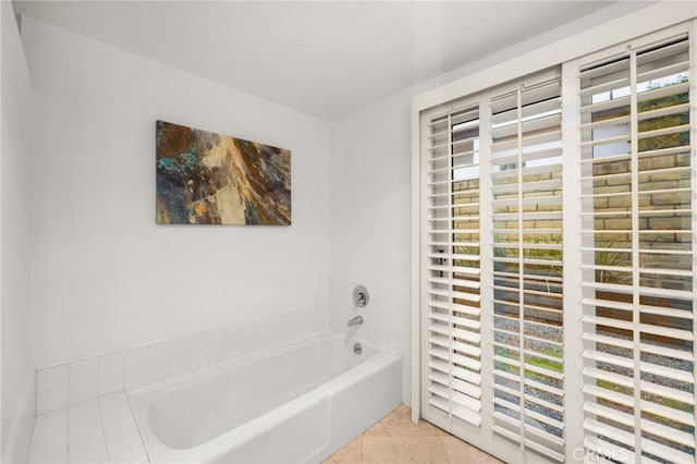 bathroom with tile patterned flooring and a bathing tub