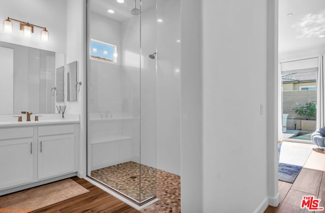 bathroom with vanity, wood-type flooring, and walk in shower