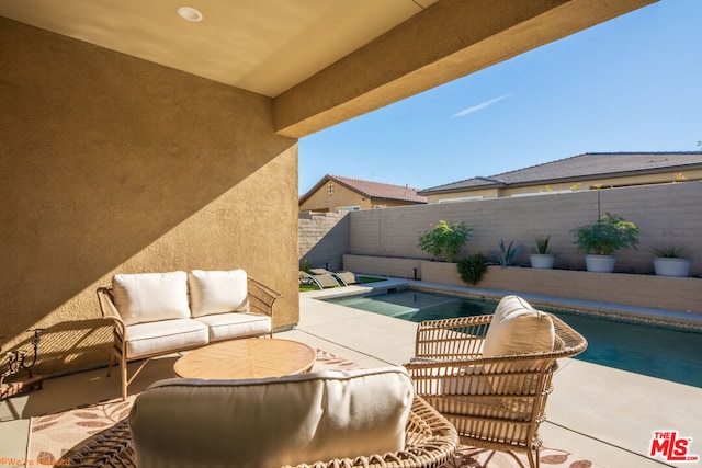 view of patio / terrace with a fenced in pool and an outdoor hangout area