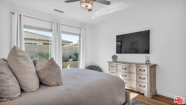 bedroom with wood-type flooring and ceiling fan