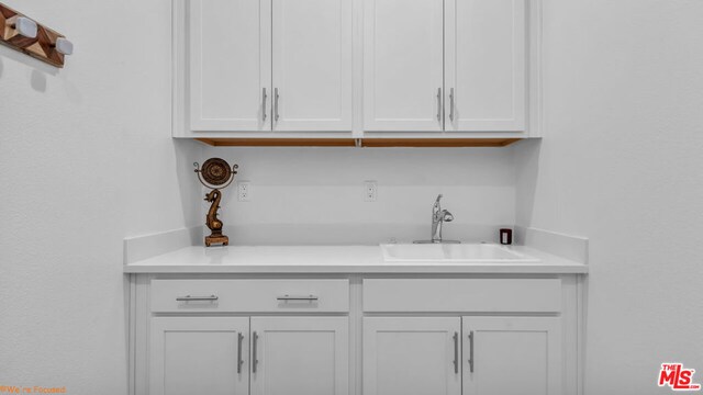 interior space with sink and white cabinets