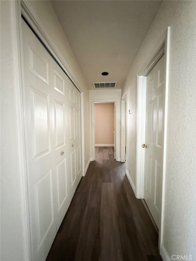 hallway with dark wood-type flooring