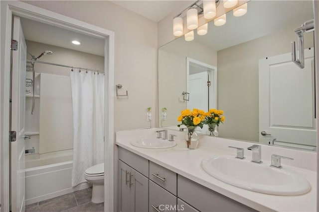 full bathroom featuring vanity, shower / bath combo with shower curtain, tile patterned flooring, and toilet