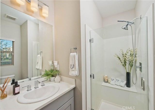 bathroom featuring vanity and an enclosed shower