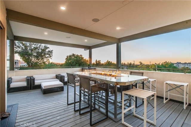 deck at dusk with an outdoor living space