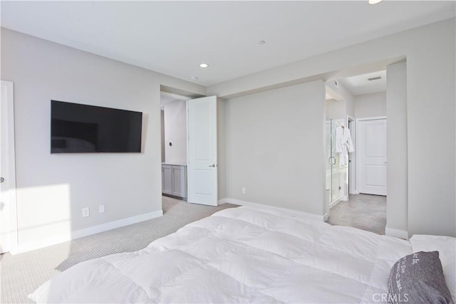 carpeted bedroom featuring ensuite bath