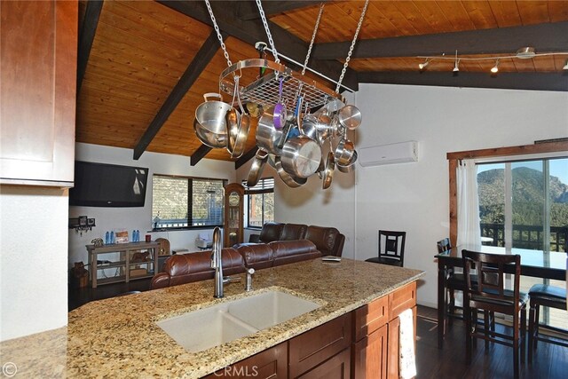 kitchen featuring vaulted ceiling with beams, wood ceiling, plenty of natural light, and sink