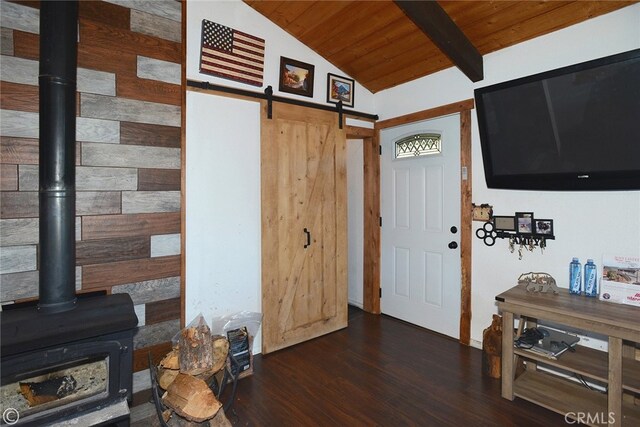 foyer entrance featuring vaulted ceiling with beams, a barn door, dark hardwood / wood-style flooring, and wooden ceiling