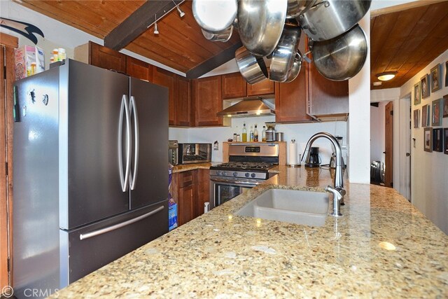 kitchen with light stone counters, wood ceiling, stainless steel appliances, extractor fan, and sink